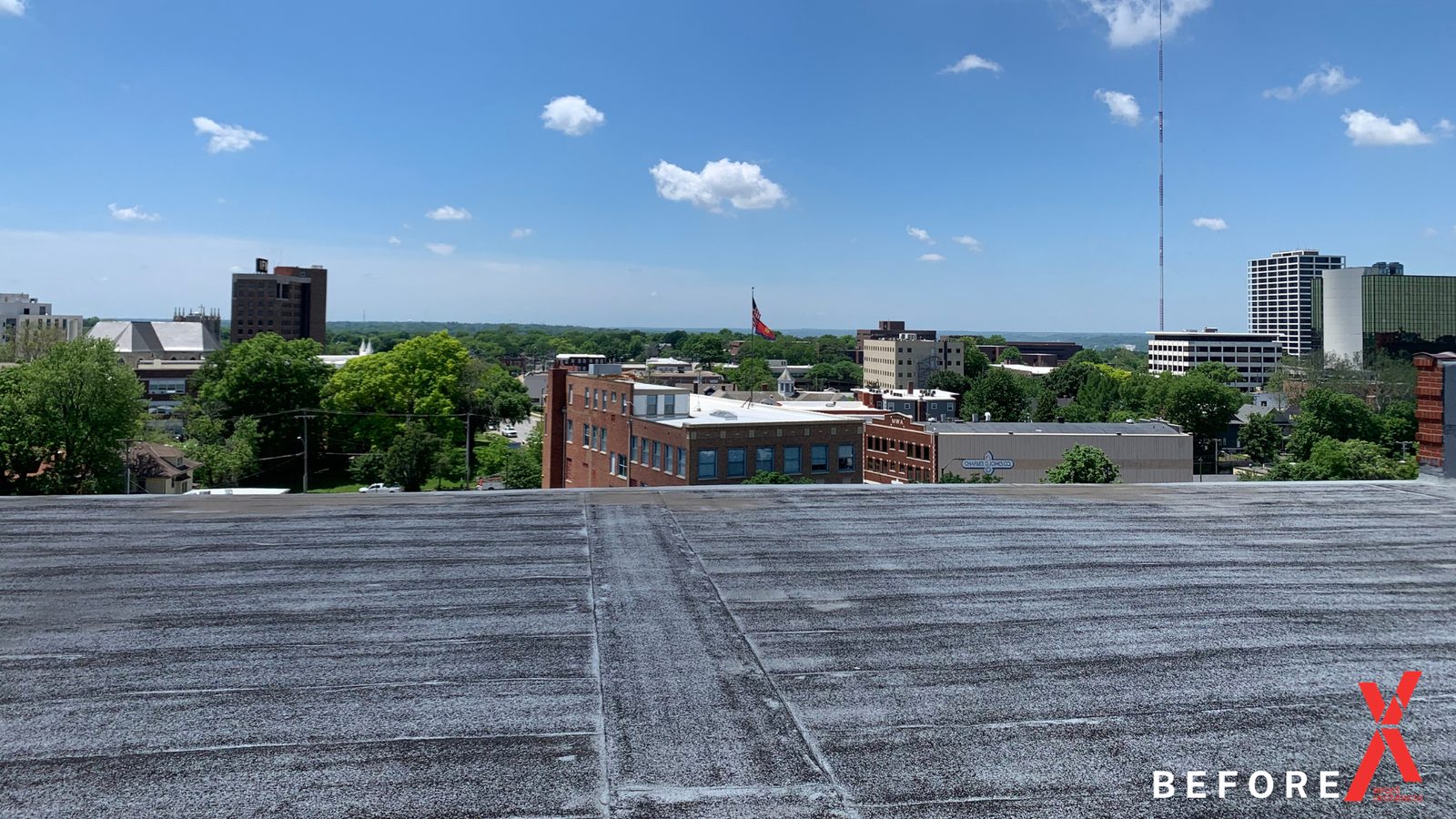 The bare roof deck as found, looking north over the city