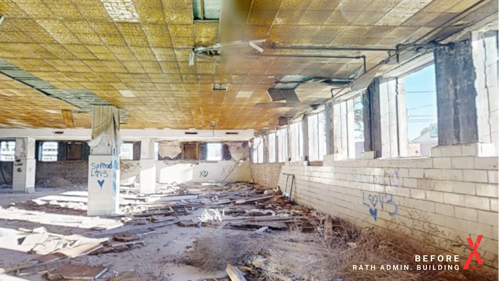 The Rath Administration Building interior as found, debris across the floor and the ceiling grid collapsing