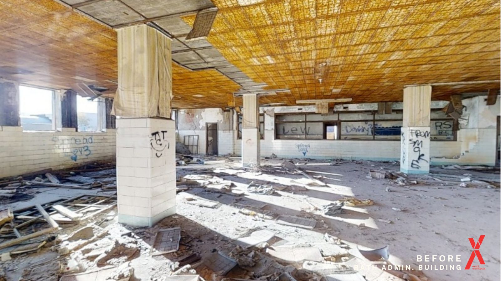 The same floor as found, daylight reaching the columns through the stripped window line